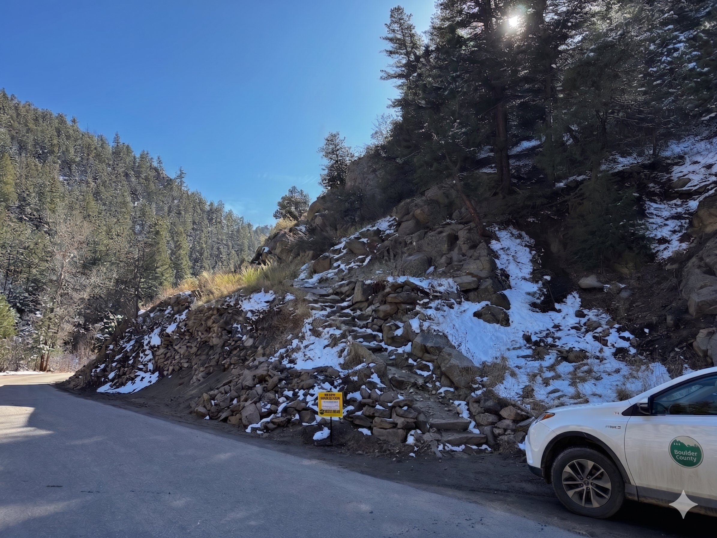 The real Boulder County build site: existing residence removed, county vehicle in frame for scale